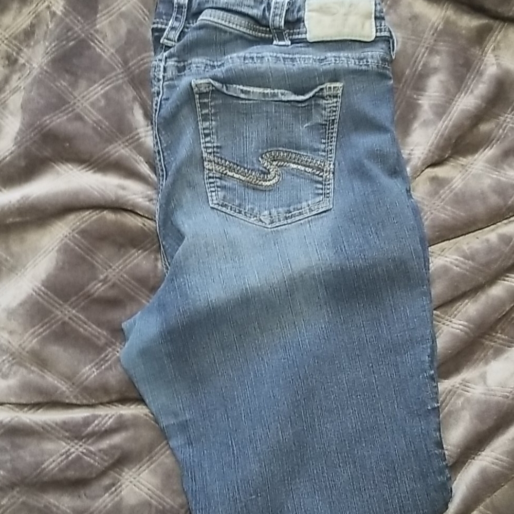 Silver jeans with slight distressing